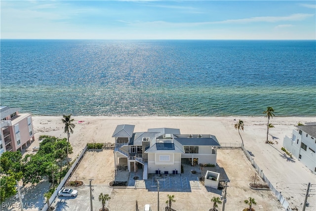 aerial view with a water view and a view of the beach