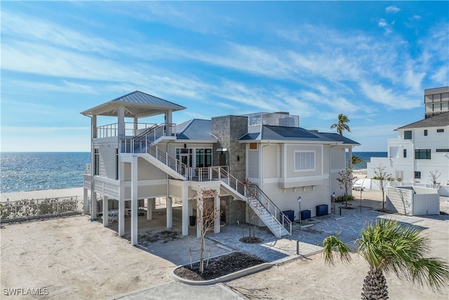 exterior space featuring a view of the beach, a water view, and a carport