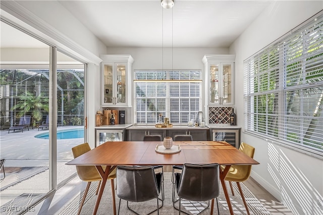 sunroom / solarium featuring plenty of natural light and beverage cooler