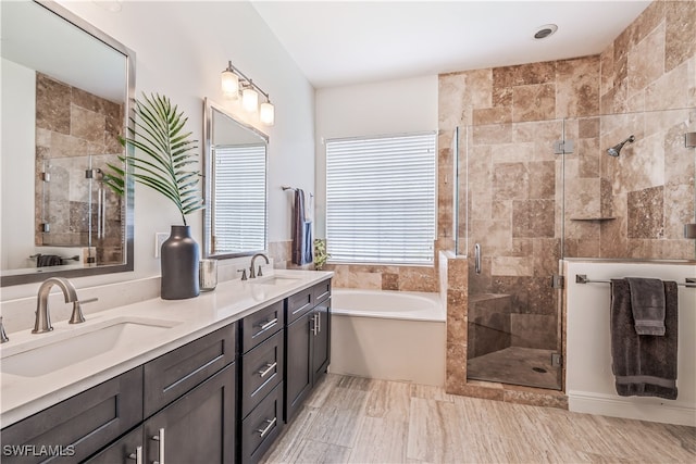 bathroom featuring vanity and shower with separate bathtub