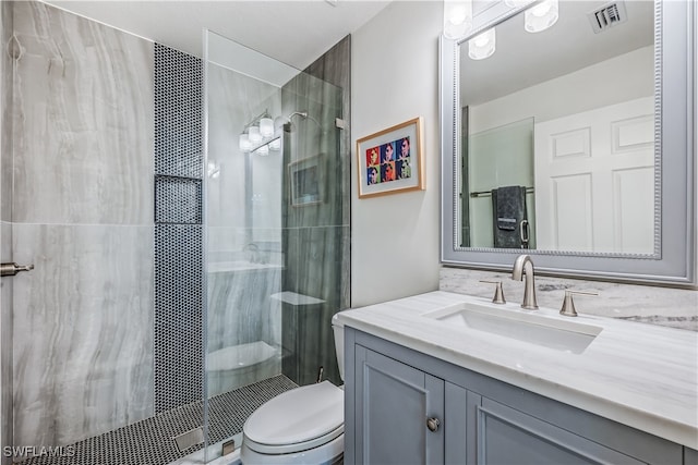 bathroom with vanity, toilet, and an enclosed shower