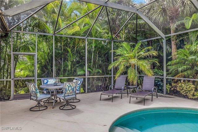 view of swimming pool with a patio area and a lanai