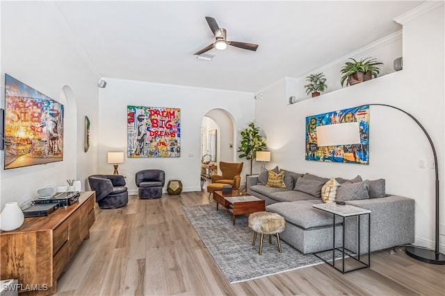 living room with light hardwood / wood-style flooring, ceiling fan, and crown molding