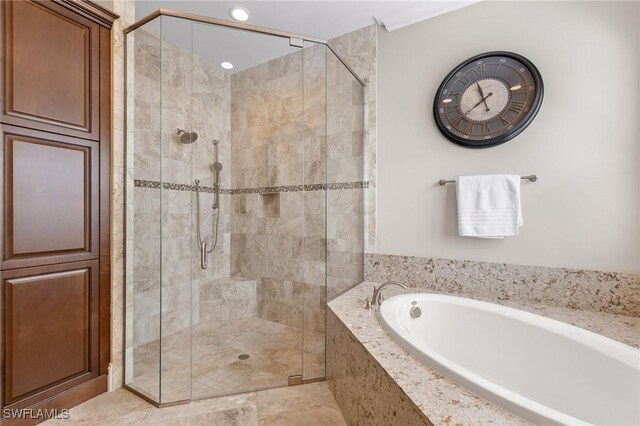 bathroom featuring independent shower and bath