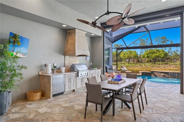 view of patio / terrace featuring a lanai, a grill, pool water feature, and an outdoor kitchen