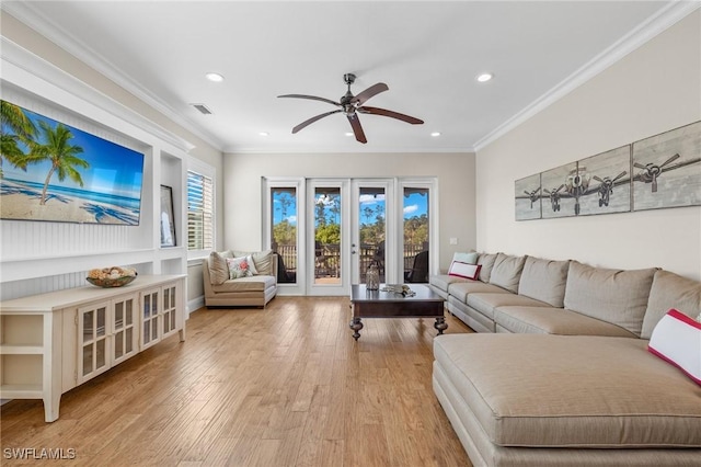 living room with ceiling fan, french doors, ornamental molding, and light wood-type flooring