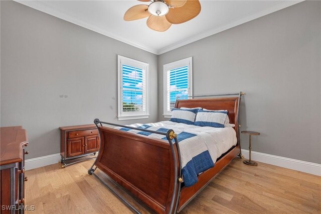 bedroom with light wood-type flooring, ceiling fan, and ornamental molding