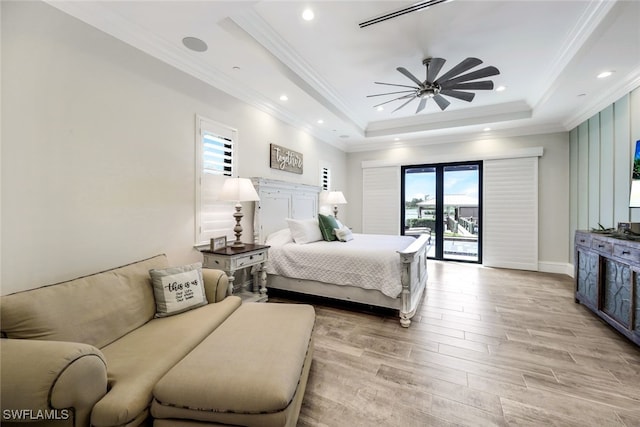 bedroom featuring a raised ceiling, ceiling fan, access to outside, light wood-type flooring, and crown molding