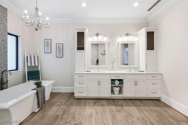 bathroom with vanity, ornamental molding, hardwood / wood-style flooring, and a bath