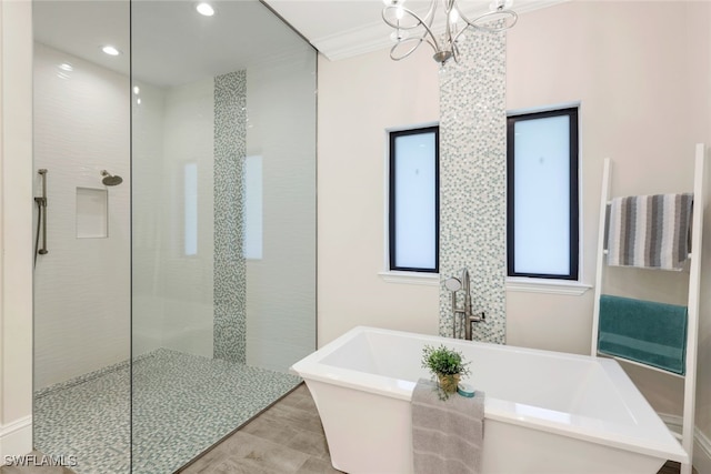 bathroom featuring a walk in shower, a freestanding bath, a chandelier, crown molding, and recessed lighting