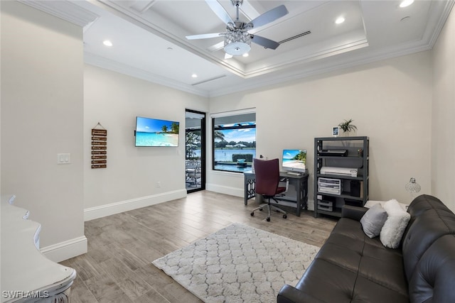 home office featuring ceiling fan, crown molding, and light wood-type flooring