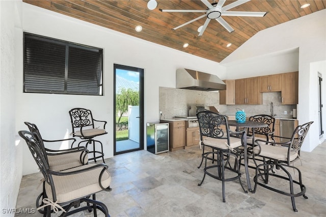 dining room with wooden ceiling, a ceiling fan, wine cooler, and high vaulted ceiling