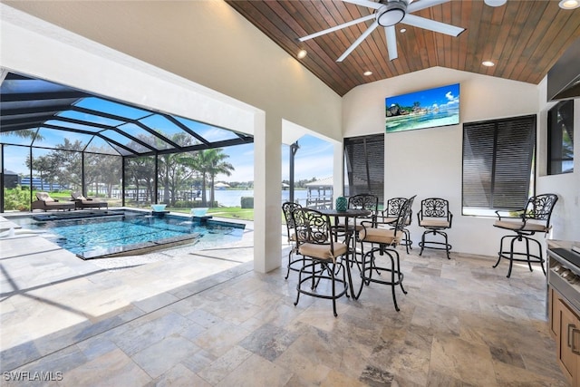 view of pool with a patio, ceiling fan, a water view, and glass enclosure