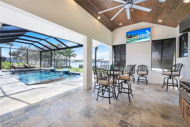 outdoor pool featuring ceiling fan, a patio area, glass enclosure, and a water view