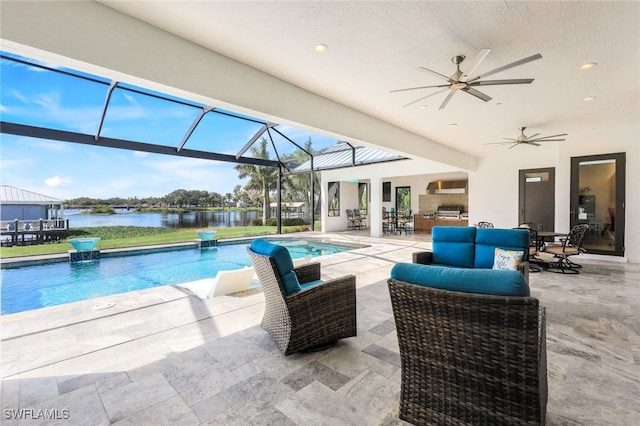 view of pool featuring an outdoor hangout area, ceiling fan, a lanai, a patio area, and a water view