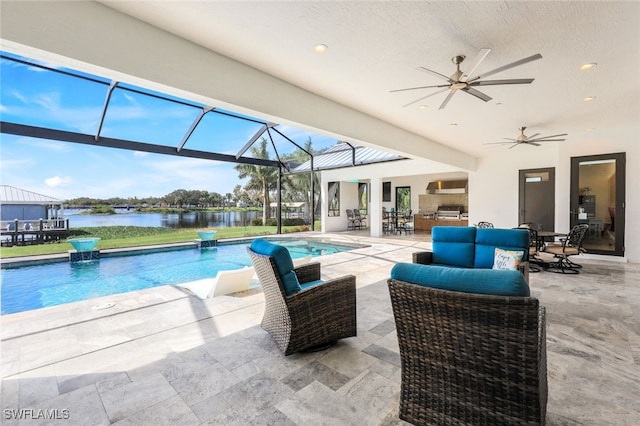 outdoor pool with an outdoor living space, a patio area, ceiling fan, a water view, and glass enclosure