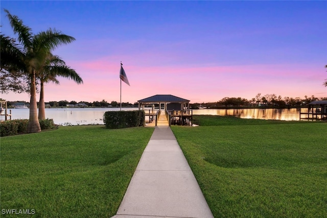 view of community with a gazebo, a yard, and a water view