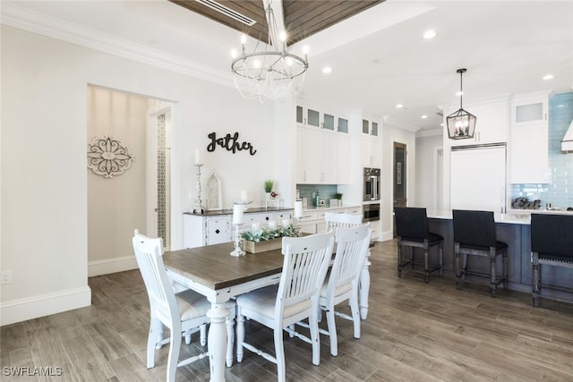 dining room with ornamental molding and hardwood / wood-style flooring