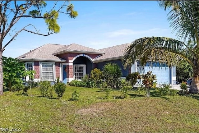 ranch-style house featuring a front yard and a garage