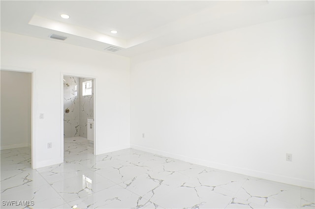 empty room with a raised ceiling