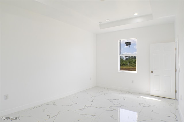 spare room featuring a raised ceiling