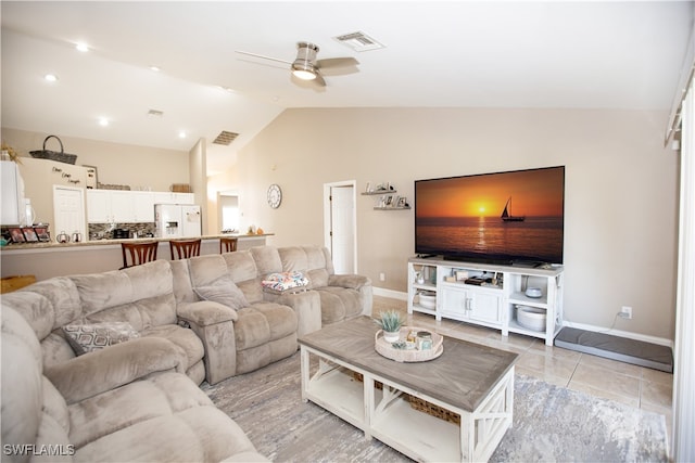 living room featuring vaulted ceiling, light tile patterned floors, and ceiling fan