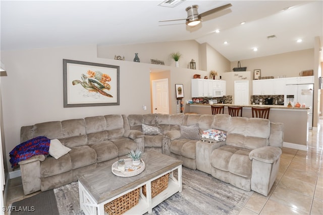 tiled living room featuring lofted ceiling and ceiling fan