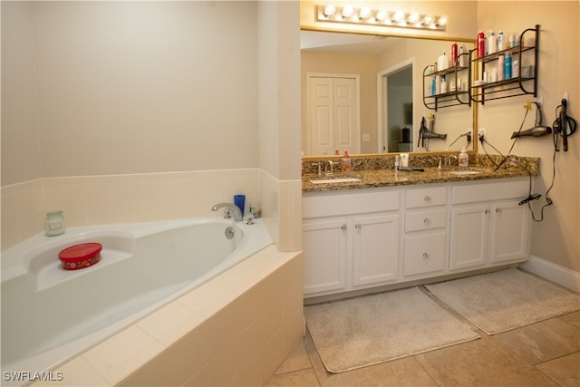 bathroom with vanity, tiled tub, and tile patterned floors