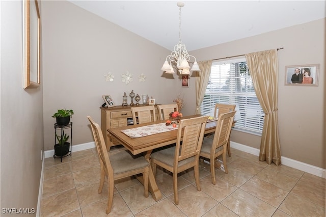 dining area featuring light tile patterned floors and an inviting chandelier