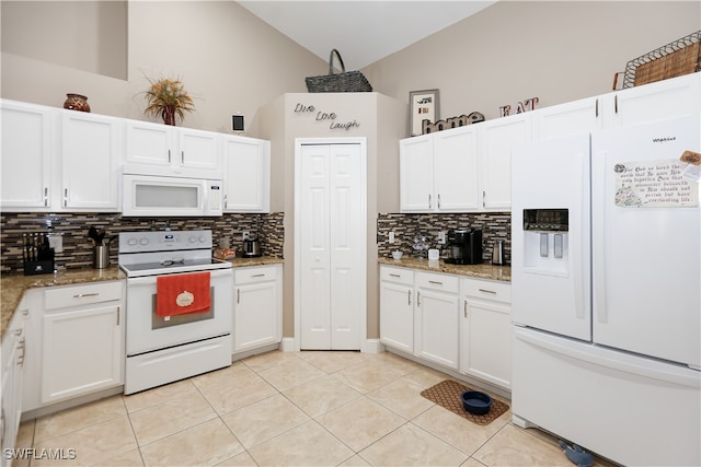 kitchen featuring tasteful backsplash, high vaulted ceiling, light stone countertops, and white appliances