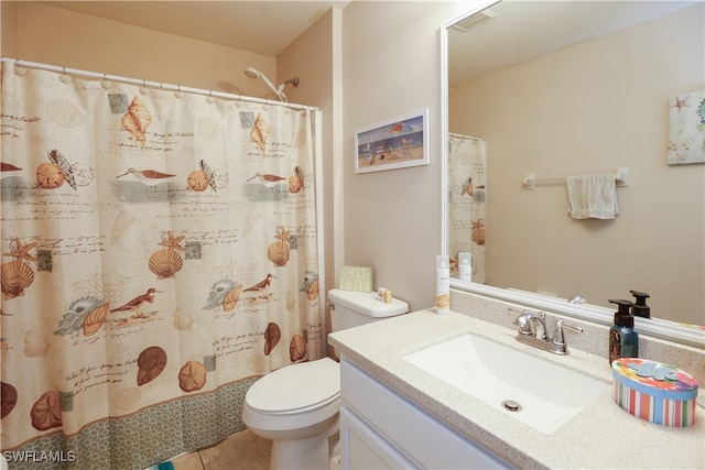 bathroom featuring walk in shower, vanity, toilet, and tile patterned floors