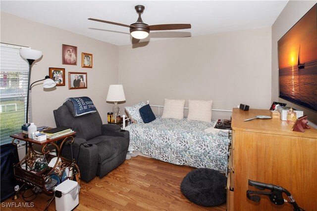 bedroom with ceiling fan and hardwood / wood-style flooring