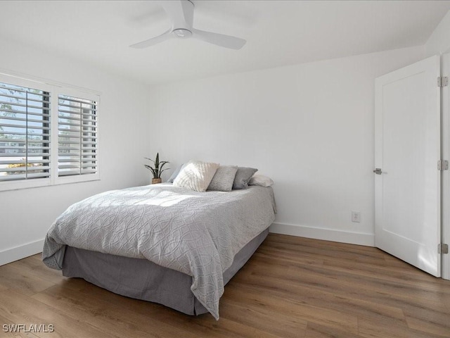 bedroom featuring hardwood / wood-style flooring and ceiling fan