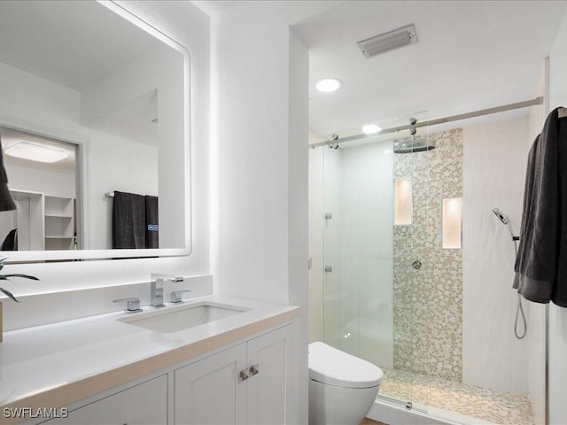 bathroom with vanity, toilet, and an enclosed shower