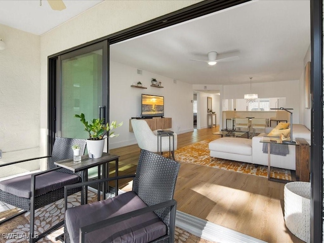 living room featuring hardwood / wood-style flooring and ceiling fan