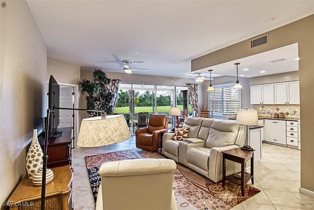 tiled living room featuring ceiling fan