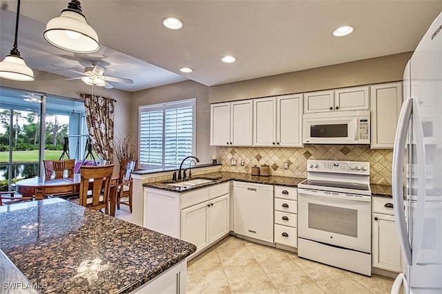 kitchen with white cabinets, a healthy amount of sunlight, pendant lighting, and white appliances