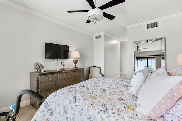 bedroom with ceiling fan, crown molding, and light hardwood / wood-style flooring