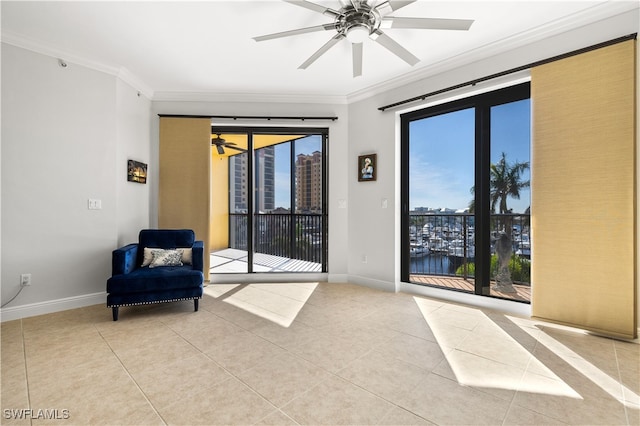 sitting room with light tile patterned floors, crown molding, and a wealth of natural light