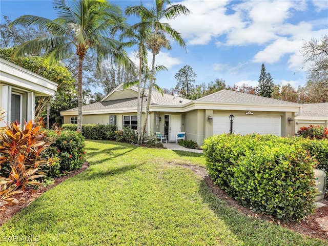 view of front of home featuring a front yard and a garage