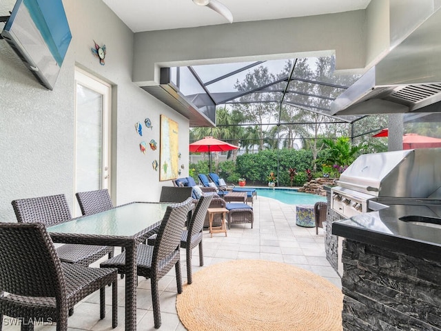 view of patio / terrace with exterior kitchen, a lanai, and grilling area