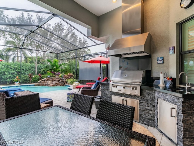 view of patio / terrace featuring an outdoor kitchen, glass enclosure, sink, and grilling area