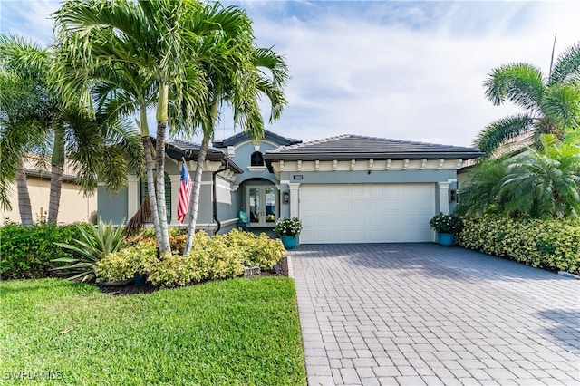 view of front of house featuring a garage and a front lawn