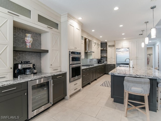 kitchen featuring stainless steel appliances, white cabinetry, wine cooler, and backsplash