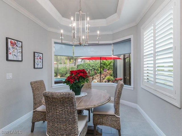 tiled dining space with an inviting chandelier, a healthy amount of sunlight, and crown molding