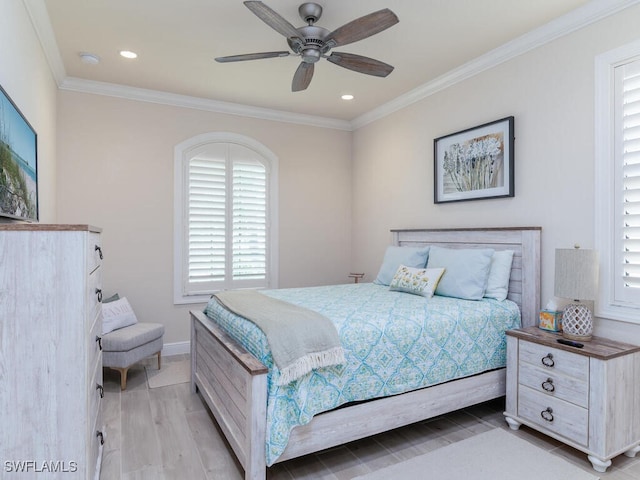 bedroom featuring ceiling fan, light hardwood / wood-style flooring, and ornamental molding