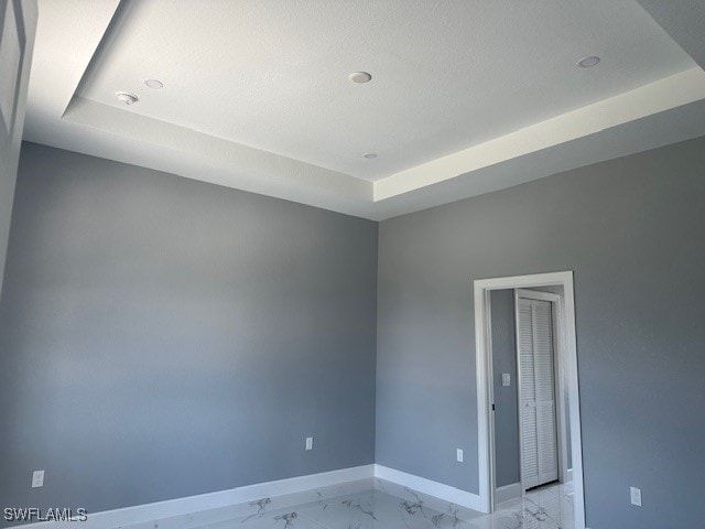 empty room with a tray ceiling