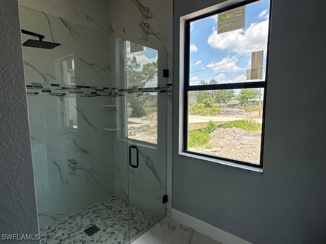 bathroom featuring a shower with door