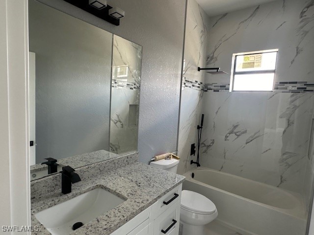 full bathroom with toilet, tiled shower / bath combo, and vanity