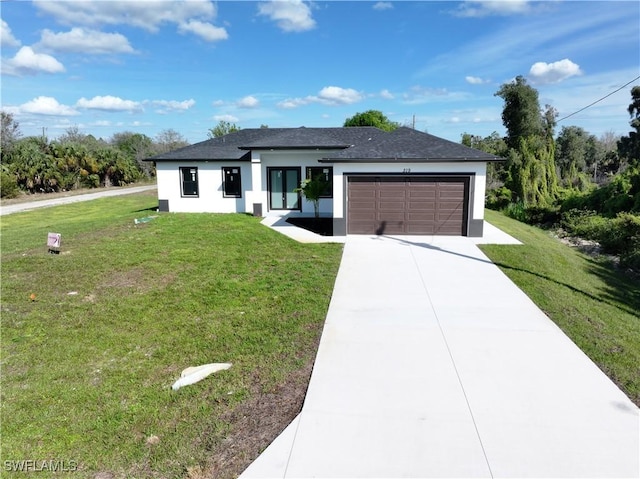 view of front of property with concrete driveway, an attached garage, a front lawn, and stucco siding